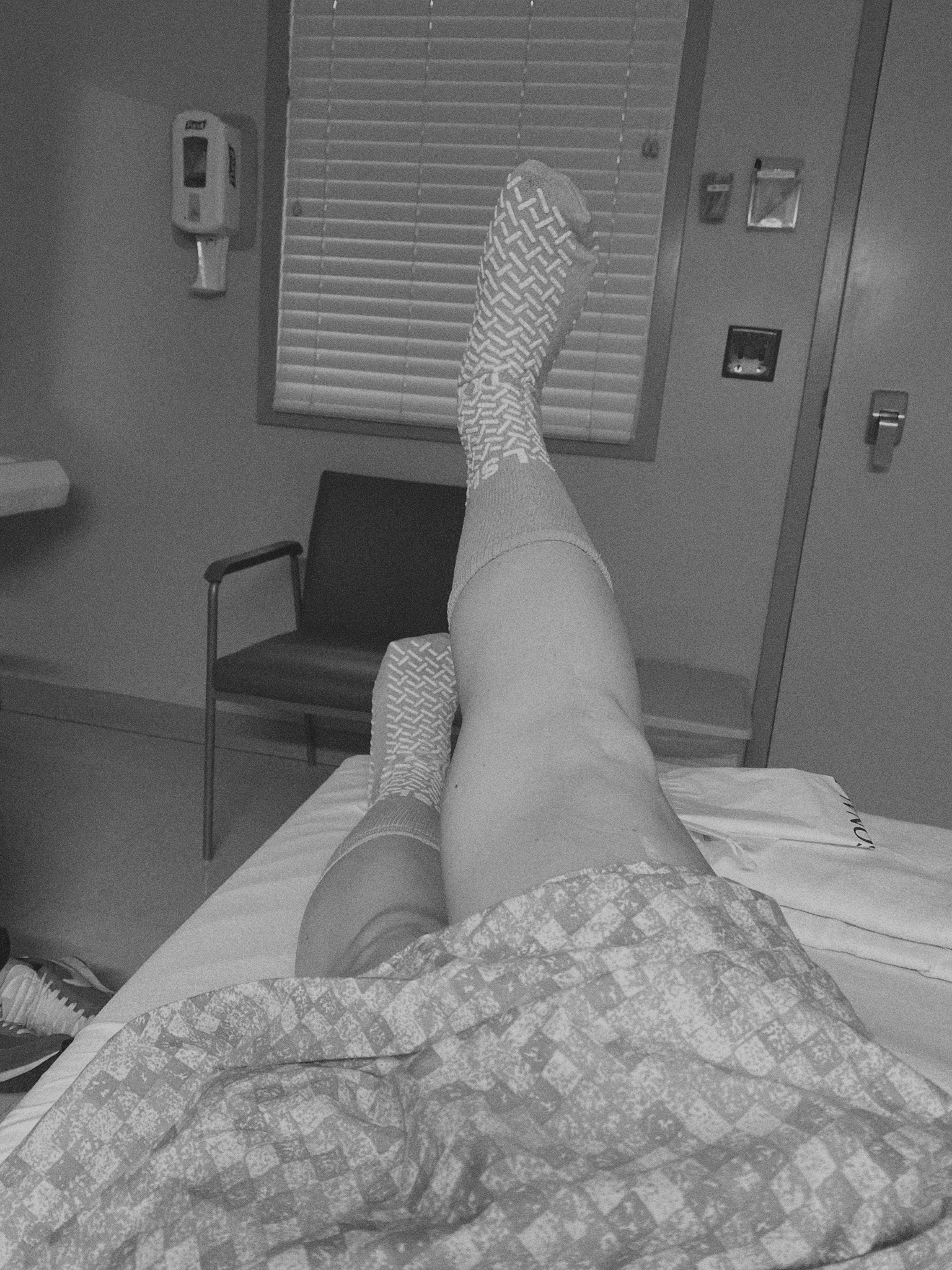 Savannah's legs laying down in a hospital bed