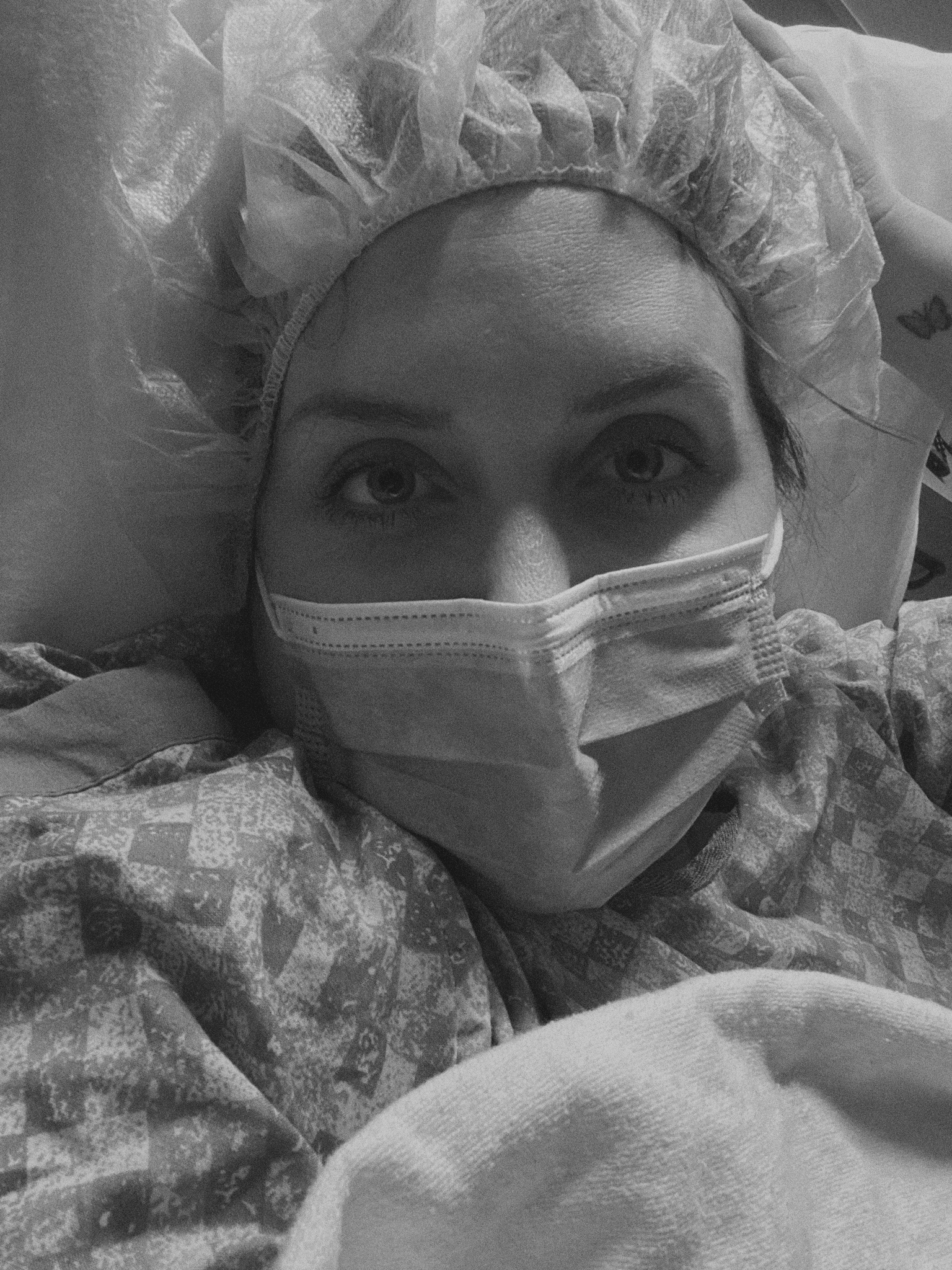 Selfie photo of Savannah in the hospital with a face mask on